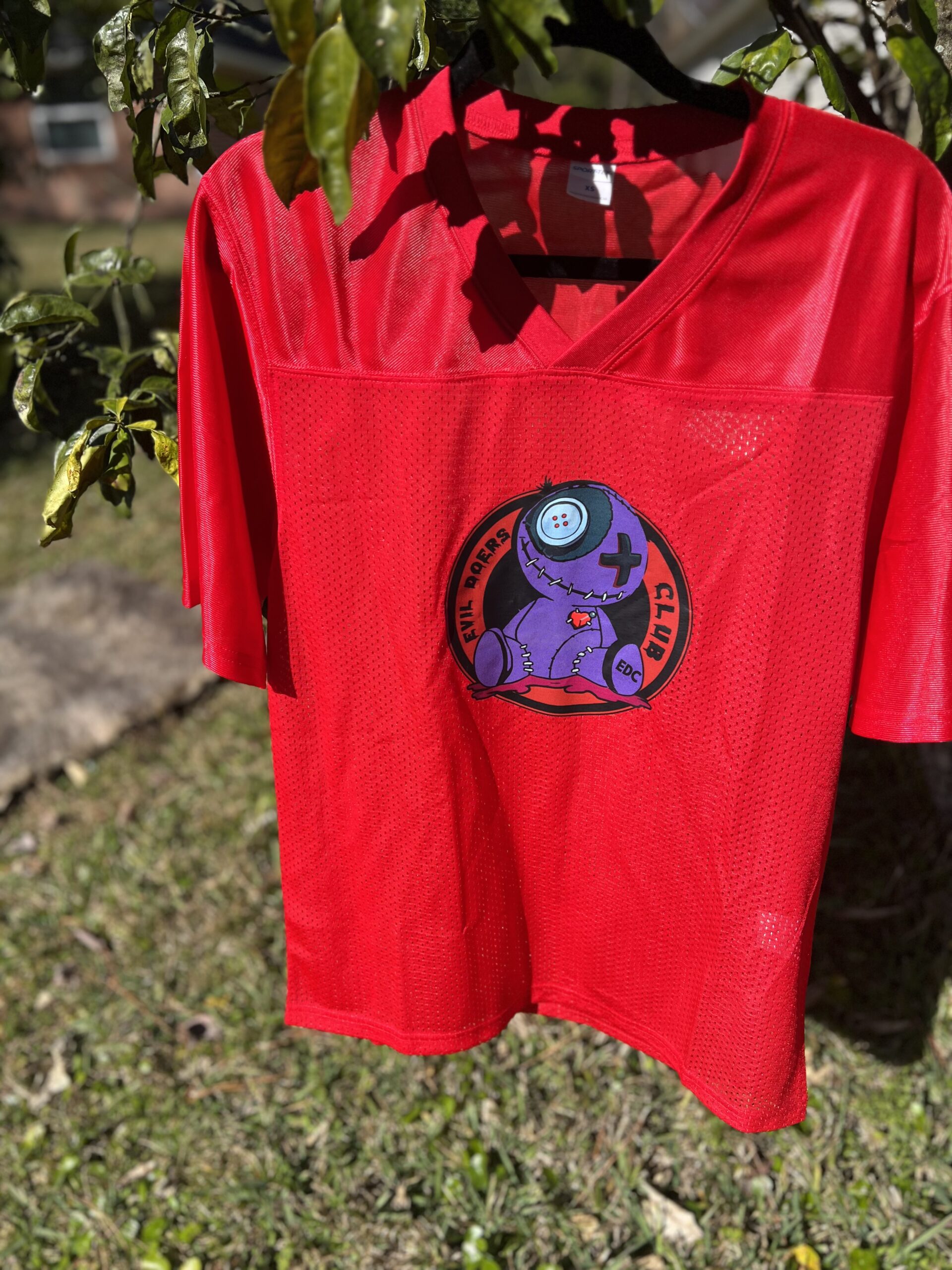 Red Jersey With Circular Voodoo Doll Logo